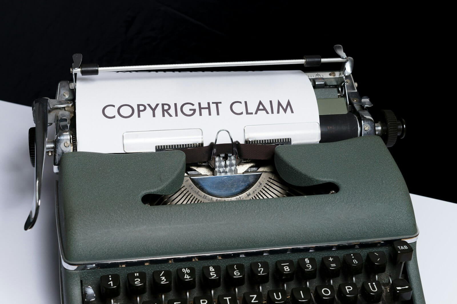 Typewriter with the words COPYRIGHT CLAIM typed on a sheet of paper